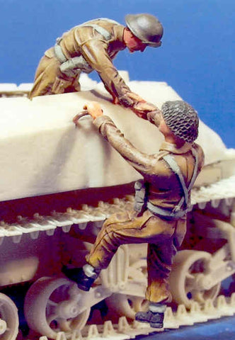 2 UK soldiers climbing on vehicle
