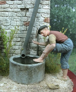 Man washing his feet in a water tub