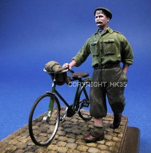 Civilian pushing on his bike