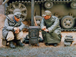 2 SS Grenadiers warming themselves by stove